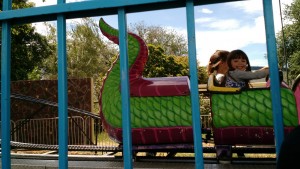 Avalina riding the castle/dragon ride with a new friend