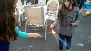 Adi and Ama helping keep each other's sparklers lit